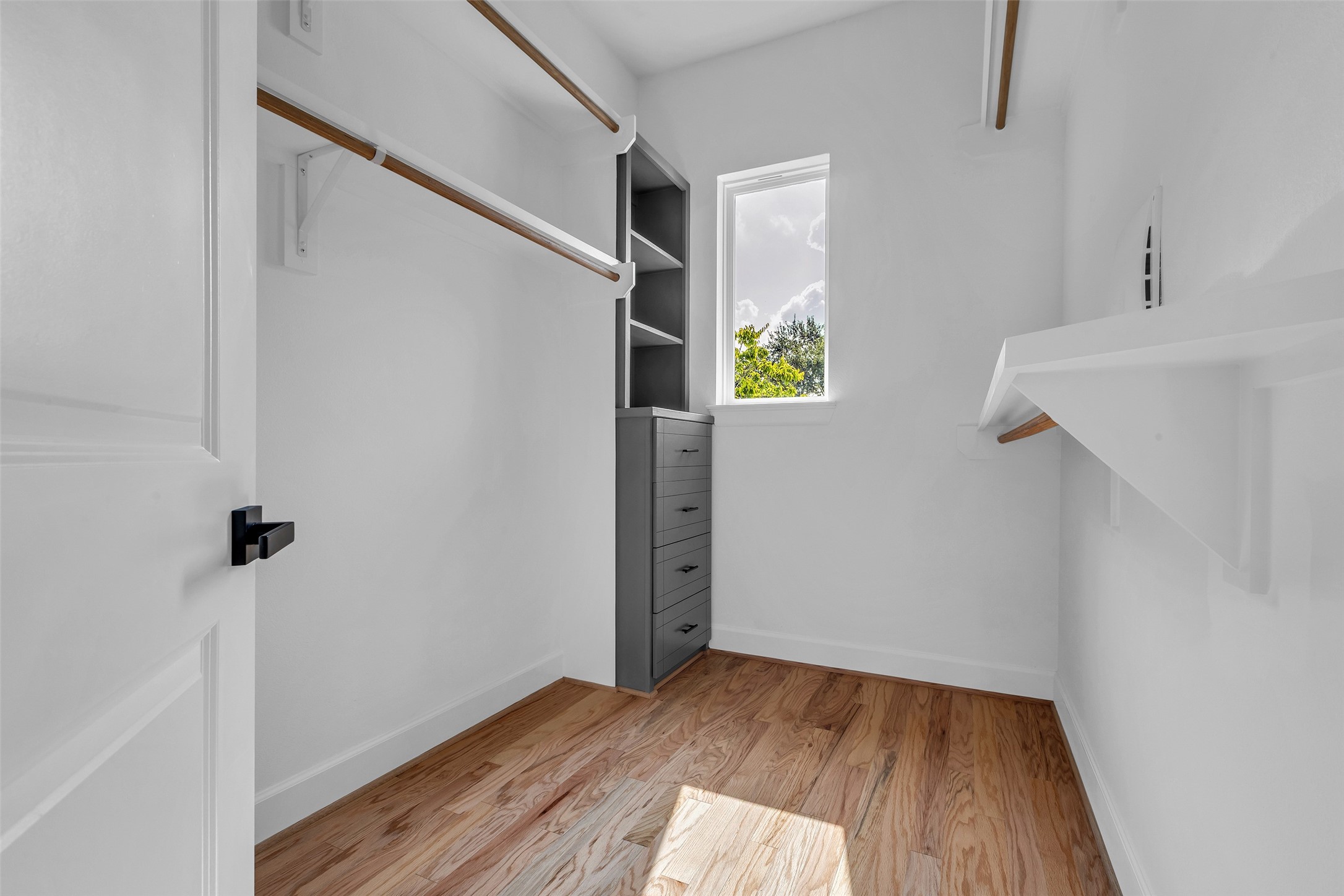 9426 Campbell Road, Unit A Houston, TX 77080 - Photo 21 of 26 a view of an empty room with wooden floor and a window