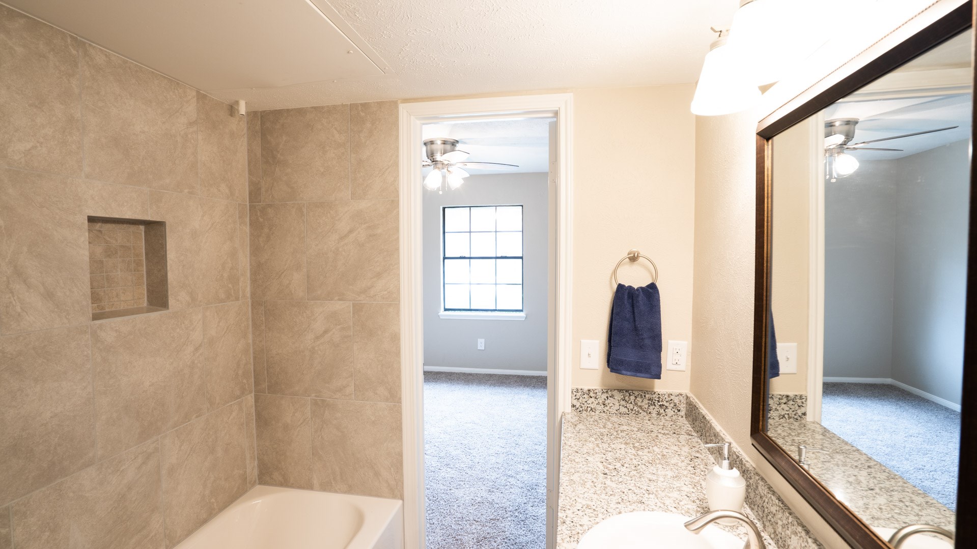 17 Regency Lane Houston, TX 77088 - Photo 11 of 23 a bathroom with a granite countertop sink and a mirror