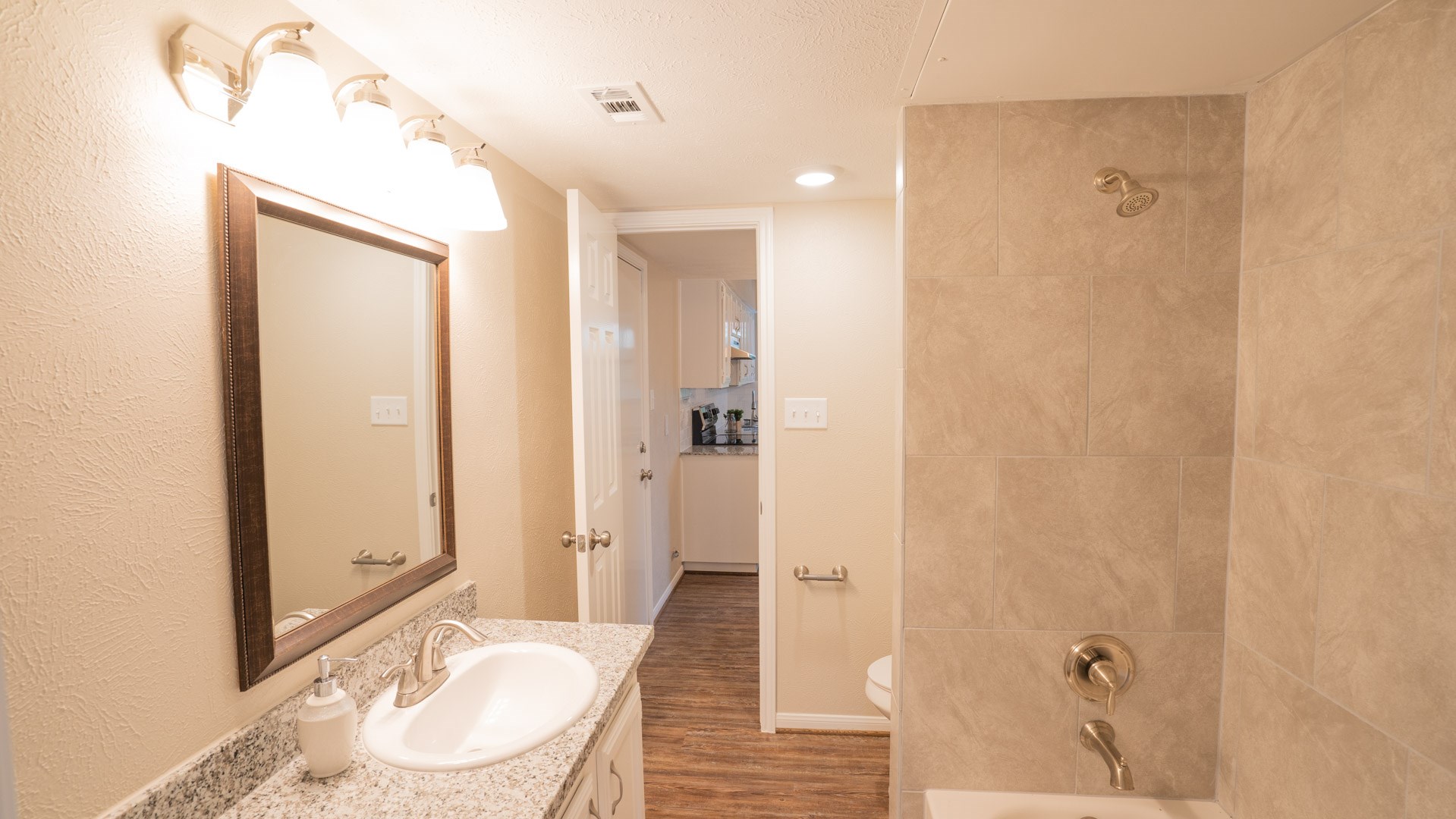 17 Regency Lane Houston, TX 77088 - Photo 12 of 23 a bathroom with a granite countertop sink a toilet and shower