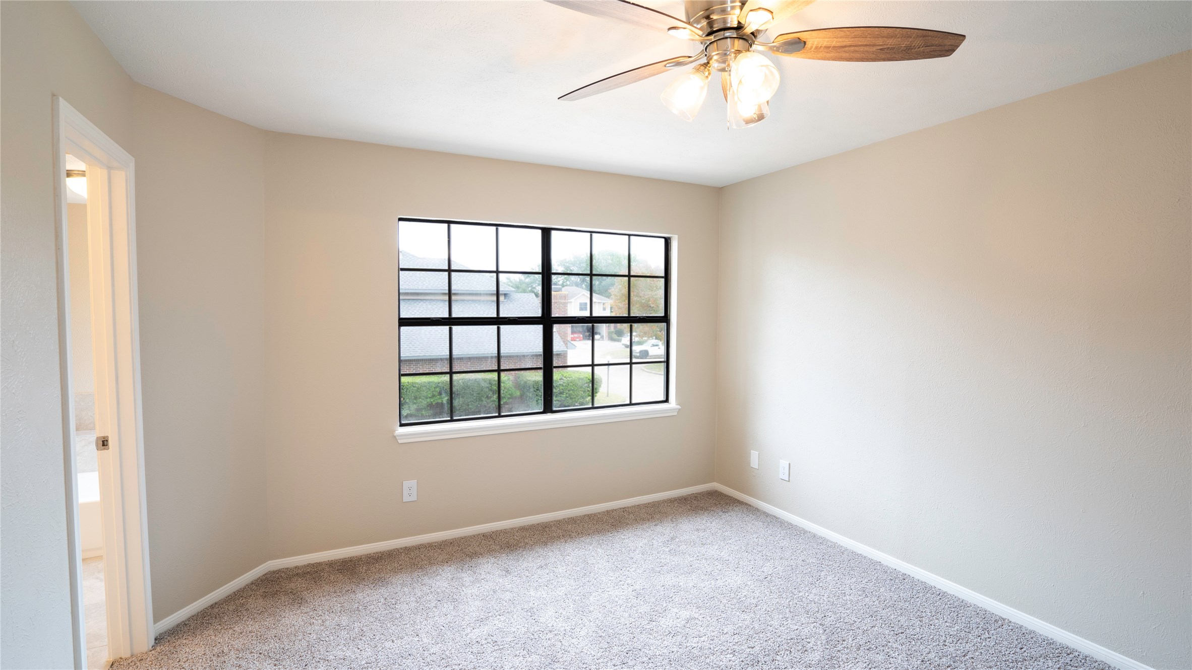 17 Regency Lane Houston, TX 77088 - Photo 20 of 23 an empty room with a window and a fan