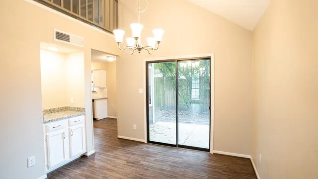 a view of a room with wooden floor and cabinet