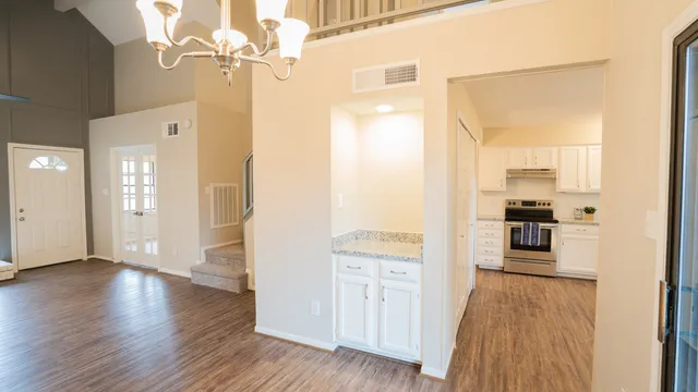 a view of a kitchen with wooden floor and a kitchen