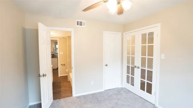 a view of a livingroom with a chandelier fan