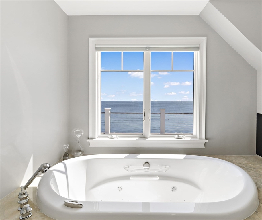 135 Stage Point Road Plymouth, MA 02360 - Photo 15 of 16 a white bath tub sitting in a bathroom next to a window