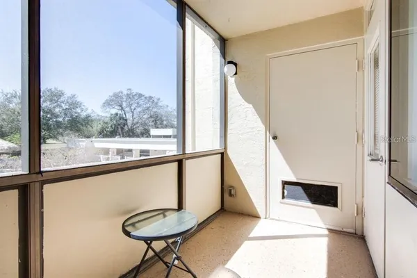 a view of a hallway with furniture and front door