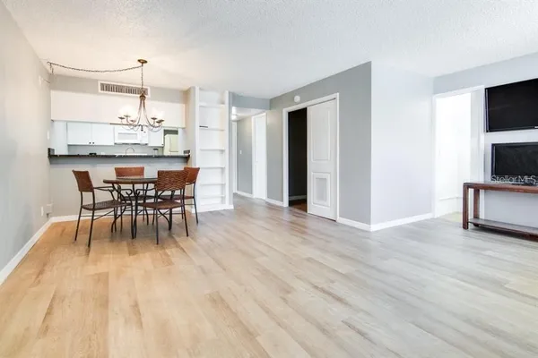 a dining room with furniture and wooden floor