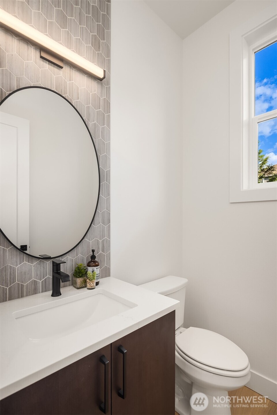 5816 Northeast 4th Place Renton, WA 98059 - Photo 6 of 25 a bathroom with a sink mirror vanity and toilet