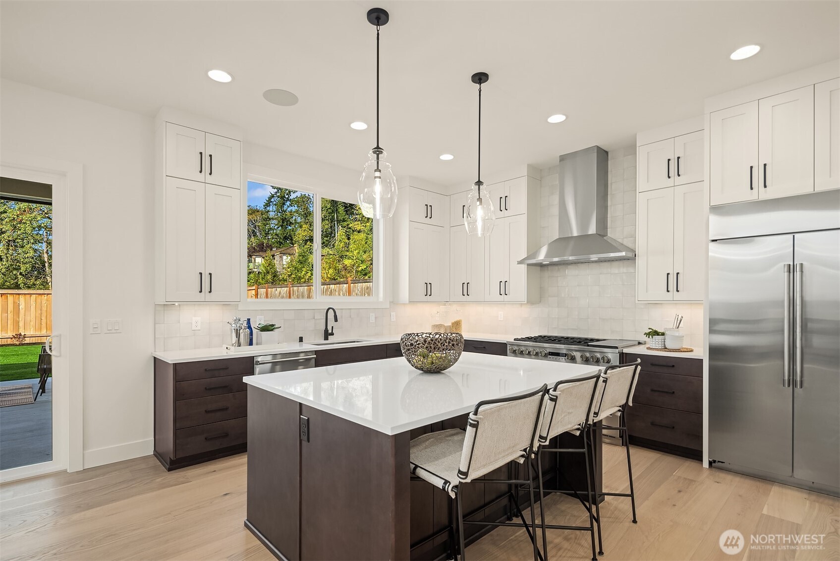 5816 Northeast 4th Place Renton, WA 98059 - Photo 9 of 25 a kitchen with stainless steel appliances granite countertop a sink a stove a refrigerator and island