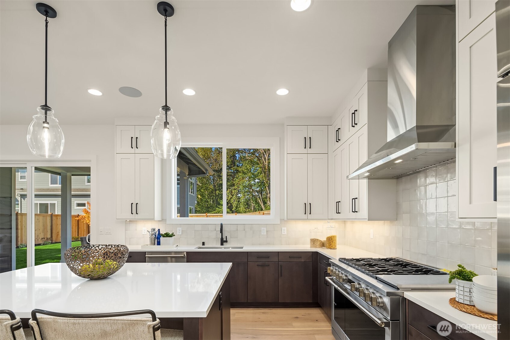 5816 Northeast 4th Place Renton, WA 98059 - Photo 10 of 25 a kitchen with stainless steel appliances granite countertop a sink a stove and a wooden floors