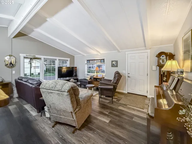a living room with furniture a dining table and a piano table