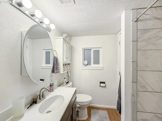 a bathroom with a sink toilet and mirror