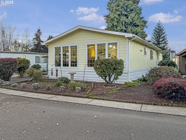 a view of a house with a yard and plants