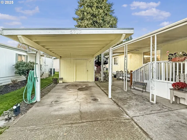 a view of a patio with table and chairs and potted plants