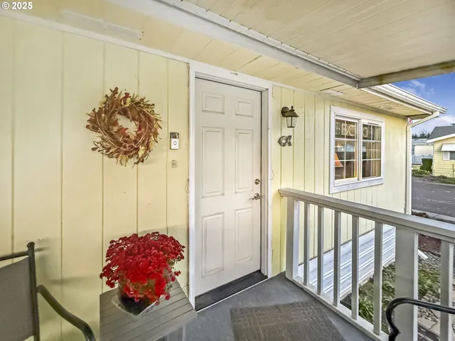 a living room with a couch and a potted plant