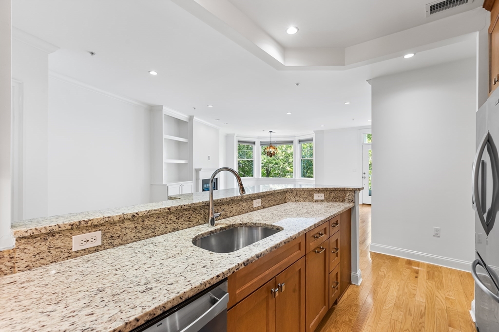 39 Taylor Drive, Unit 2006 Reading, MA 01867 - Photo 16 of 36 a kitchen with a sink a counter top space and stainless steel appliances