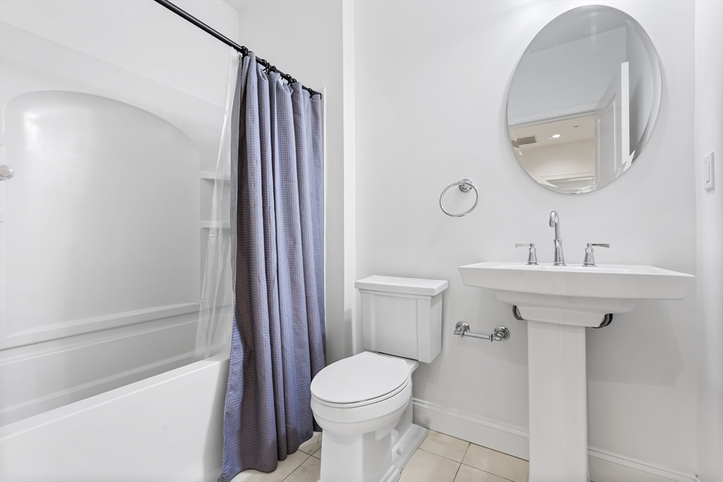 39 Taylor Drive, Unit 2006 Reading, MA 01867 - Photo 21 of 36 a bathroom with a sink a toilet and shower