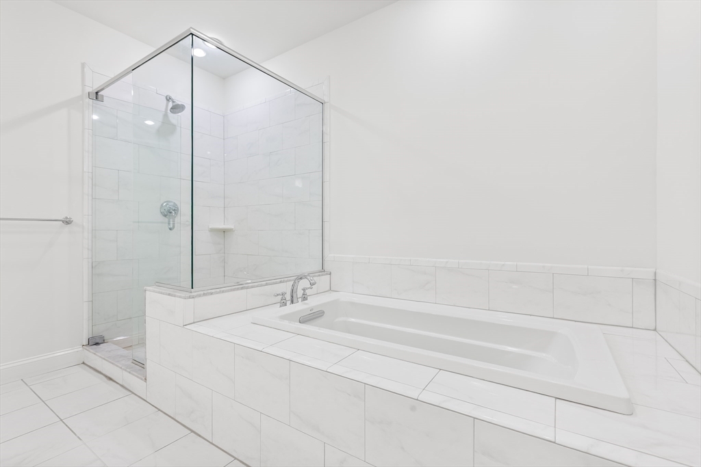 39 Taylor Drive, Unit 2006 Reading, MA 01867 - Photo 27 of 36 a bathroom with a bathtub and a shower