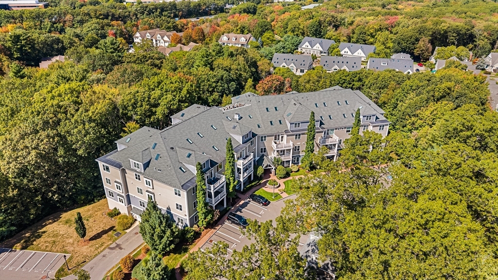 39 Taylor Drive, Unit 2006 Reading, MA 01867 - Photo 30 of 36 an aerial view of a house with swimming pool and large trees
