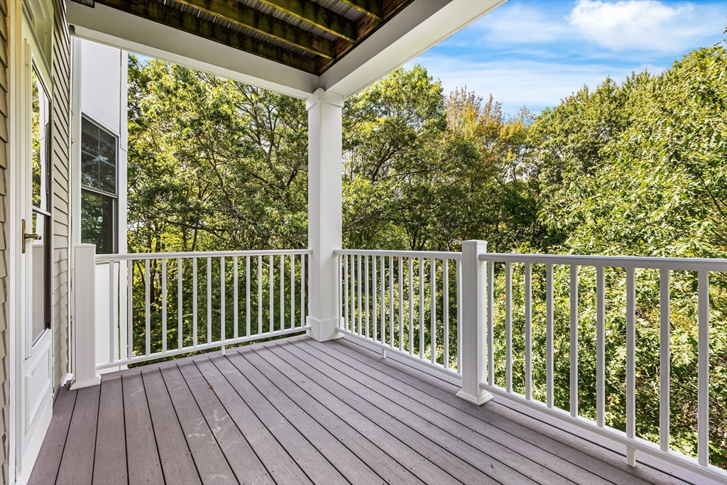 39 Taylor Drive, Unit 2006 Reading, MA 01867 - Photo 4 of 36 a view of a balcony with wooden floor