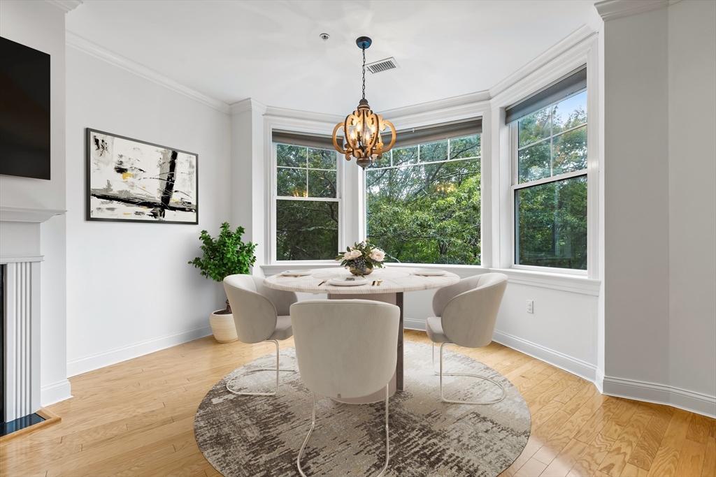 39 Taylor Drive, Unit 2006 Reading, MA 01867 - Photo 6 of 36 a living room with large window space and chandelier