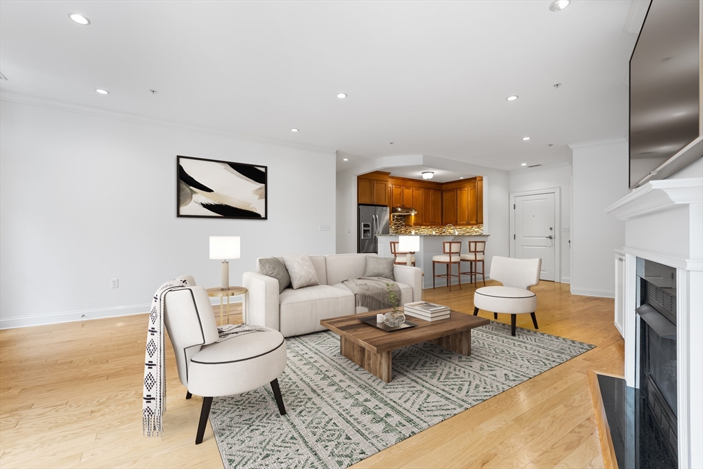 39 Taylor Drive, Unit 2006 Reading, MA 01867 - Photo 7 of 36 a living room with fireplace furniture and a flat screen tv
