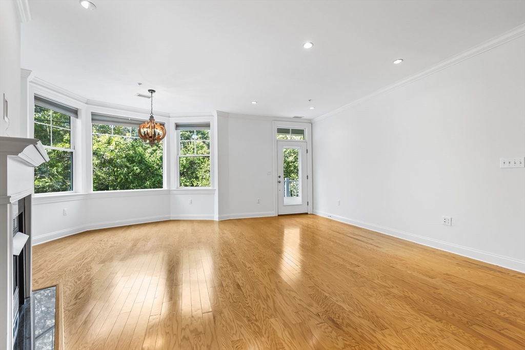 39 Taylor Drive, Unit 2006 Reading, MA 01867 - Photo 8 of 36 wooden floor in an empty room with a window