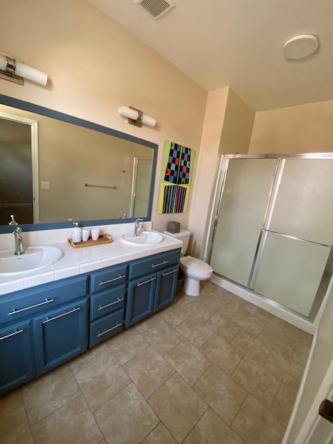 745 Haliburton Way Coalinga, CA 93210 - Photo 15 of 35 a spacious bathroom with a double vanity sink a mirror and a shower