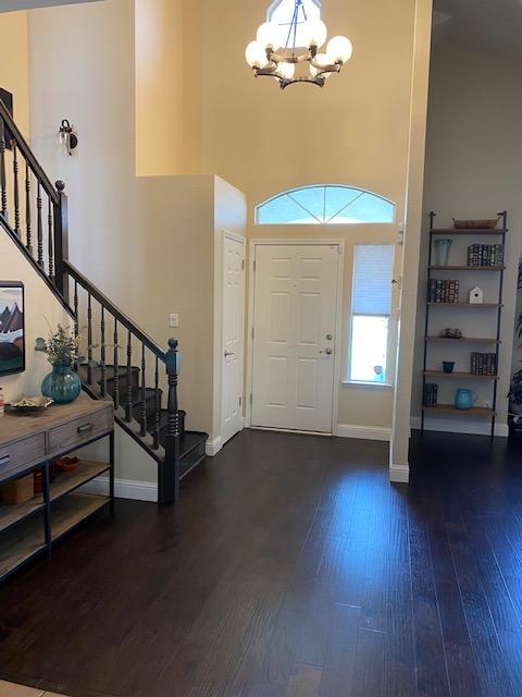745 Haliburton Way Coalinga, CA 93210 - Photo 3 of 35 an empty room with wooden floor staircase and windows