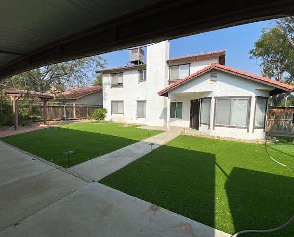 745 Haliburton Way Coalinga, CA 93210 - Photo 26 of 35 a front view of a house with a yard table and chairs