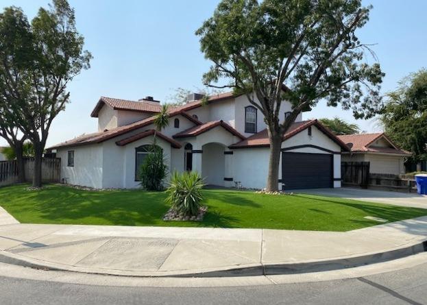 745 Haliburton Way Coalinga, CA 93210 - Photo 35 of 35 a front view of a house with a garden and trees