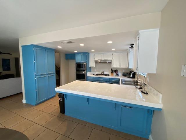 745 Haliburton Way Coalinga, CA 93210 - Photo 6 of 35 a large kitchen with kitchen island a sink stainless steel appliances and cabinets