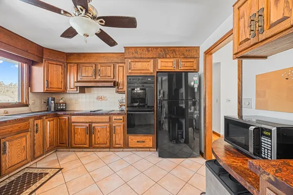 a large kitchen with stainless steel appliances granite countertop a refrigerator oven a sink and dishwasher