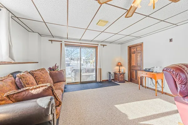 a living room with furniture a couch and two window
