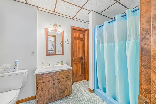 a bathroom with a double vanity sink mirror and shower