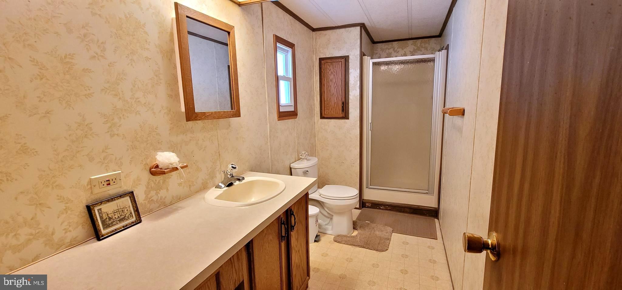 311 John Alden Drive Buena, NJ 08310 - Photo 18 of 35 a bathroom with a sink and mirror