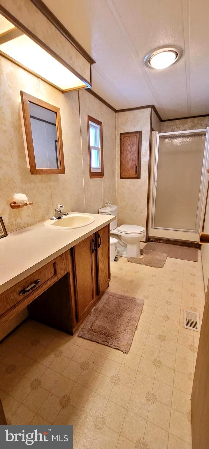311 John Alden Drive Buena, NJ 08310 - Photo 19 of 35 a bathroom with a sink vanity and a mirror