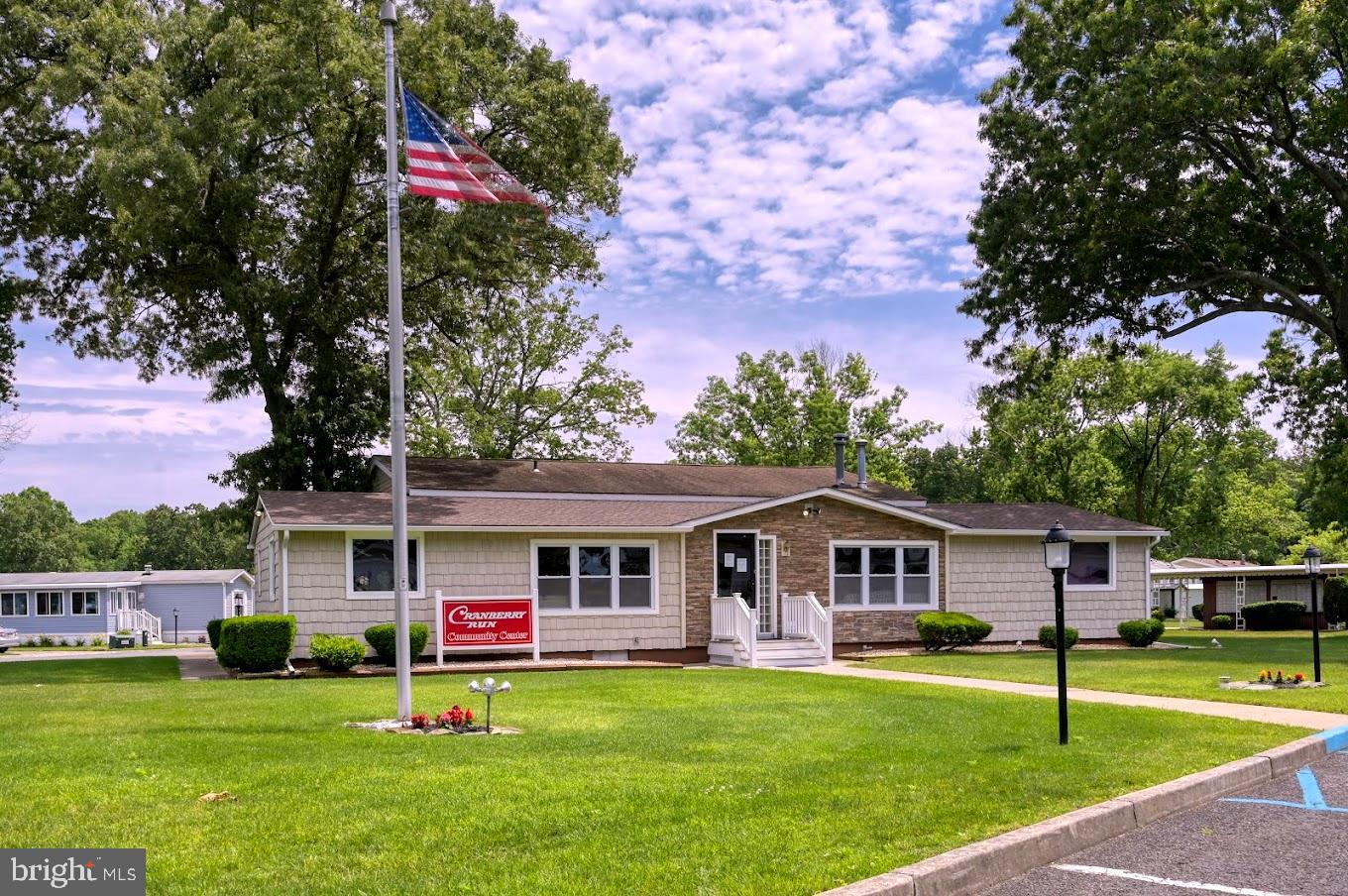 311 John Alden Drive Buena, NJ 08310 - Photo 31 of 35 a front view of a house with a garden and trees