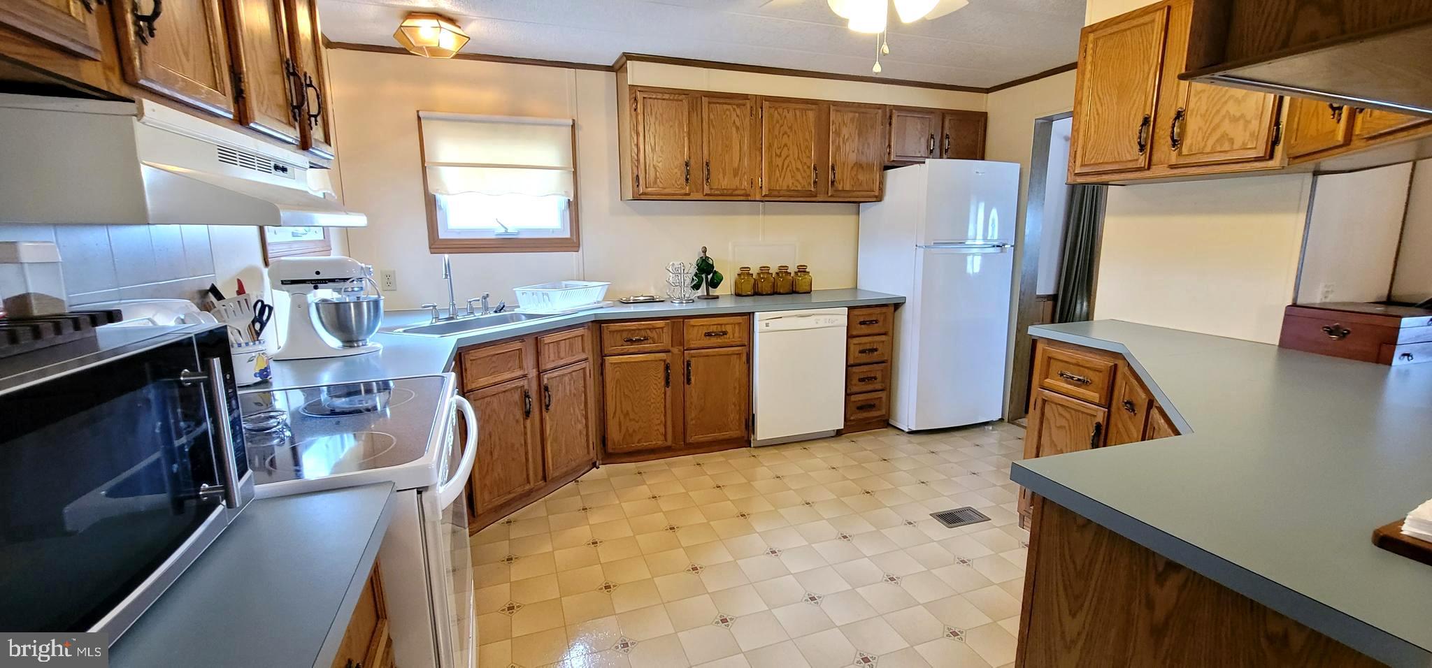 311 John Alden Drive Buena, NJ 08310 - Photo 6 of 35 a kitchen with stainless steel appliances granite countertop a sink stove and refrigerator