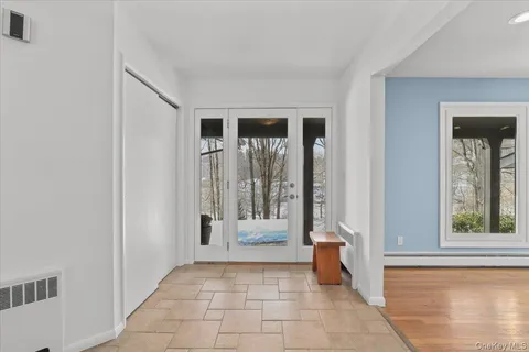 a view of a hallway with windows and dining room