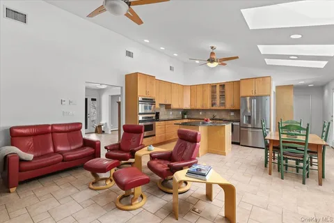 a living room with furniture kitchen view and a table