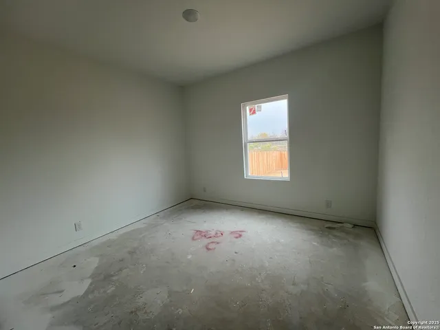 a bathroom with a granite countertop toilet and sink