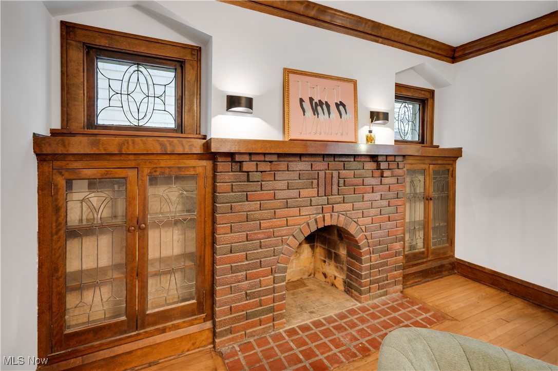 2016 Rossmoor Road Cleveland Heights, OH 44118 - Photo 11 of 46 Detailed view of wood finished floors, a fireplace, and ornamental molding