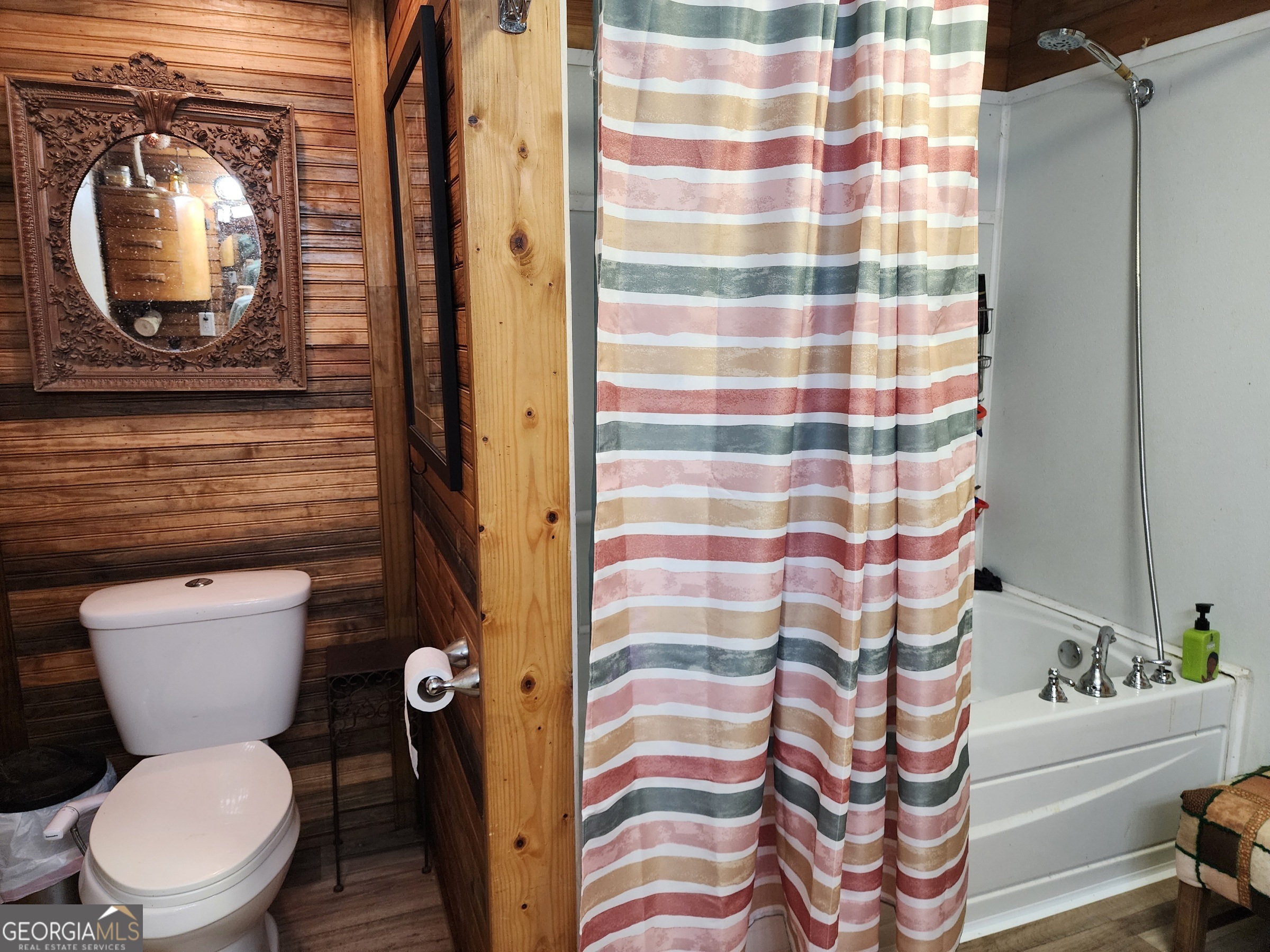 260 Old Copelan Road Southeast Eatonton, GA 31024 - Photo 19 of 88 a bathroom with a toilet and a shower curtain