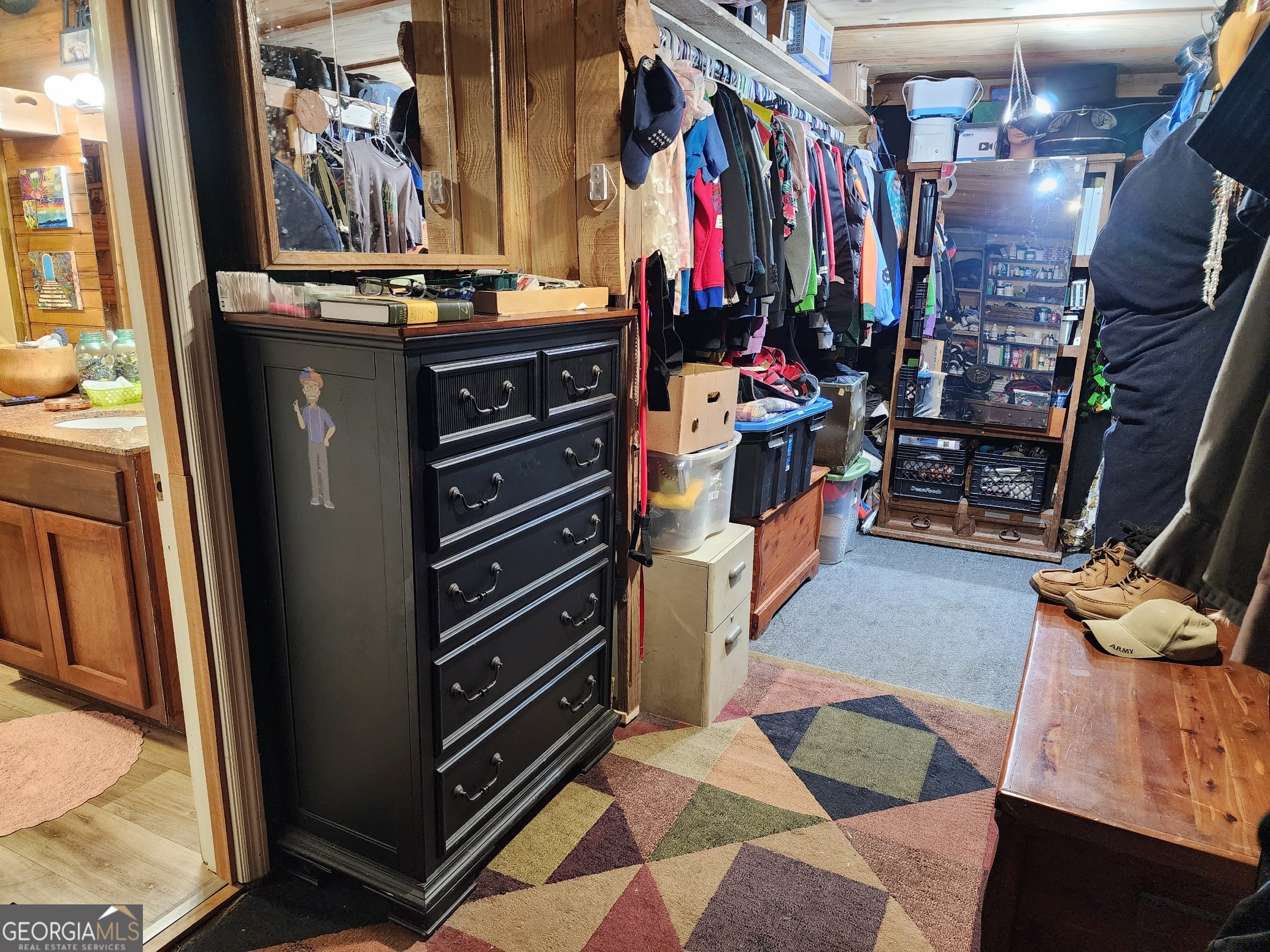 260 Old Copelan Road Southeast Eatonton, GA 31024 - Photo 22 of 88 a view of walk in closet with clothes and shoes