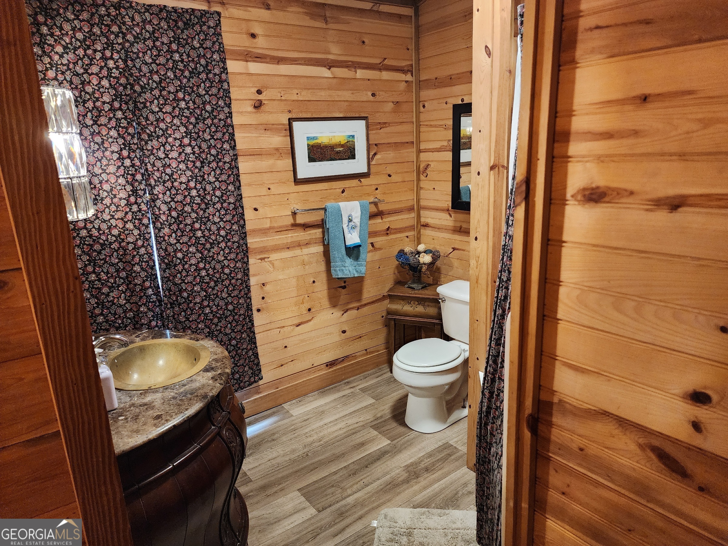 260 Old Copelan Road Southeast Eatonton, GA 31024 - Photo 40 of 88 a bathroom with a granite countertop toilet and a sink