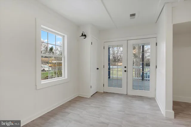 an empty room with windows and closet