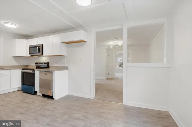 a view of kitchen with sink and cabinets