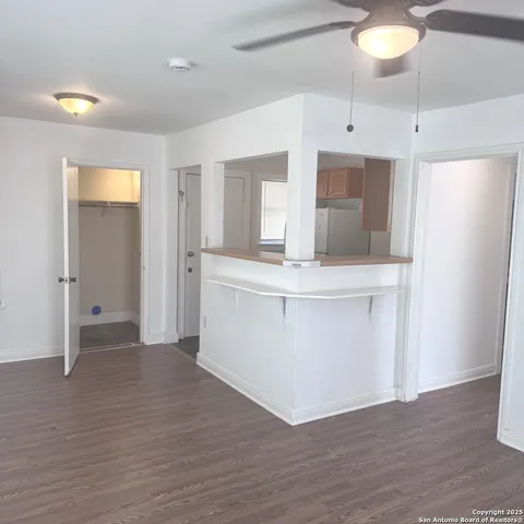 a view of kitchen with granite countertop cabinets and wooden floor