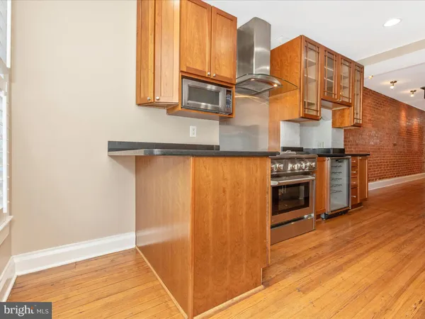 a kitchen with stainless steel appliances granite countertop a refrigerator and cabinets