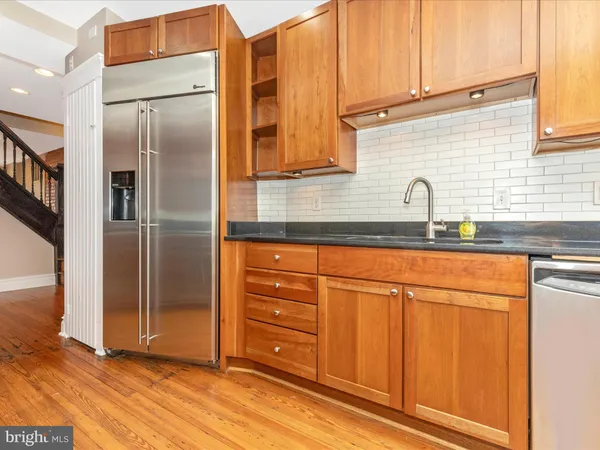 a kitchen with granite countertop cabinets and black stainless steel appliances